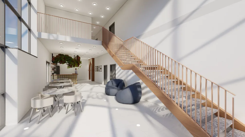 Ein heller Innenraum empfängt die Gläubigen. Die Visualisierung zeigt: Die Moschee des Vereins ist nicht nur ein religiöses Zentrum, sondern auch ein Ort des Austauschs. Im hell beleuchteten Eingangsbereich führt eine Treppe in das obere Stockwerk, während im unteren Stockwerk mehrere Tische und Stühle zum Verweilen einladen.